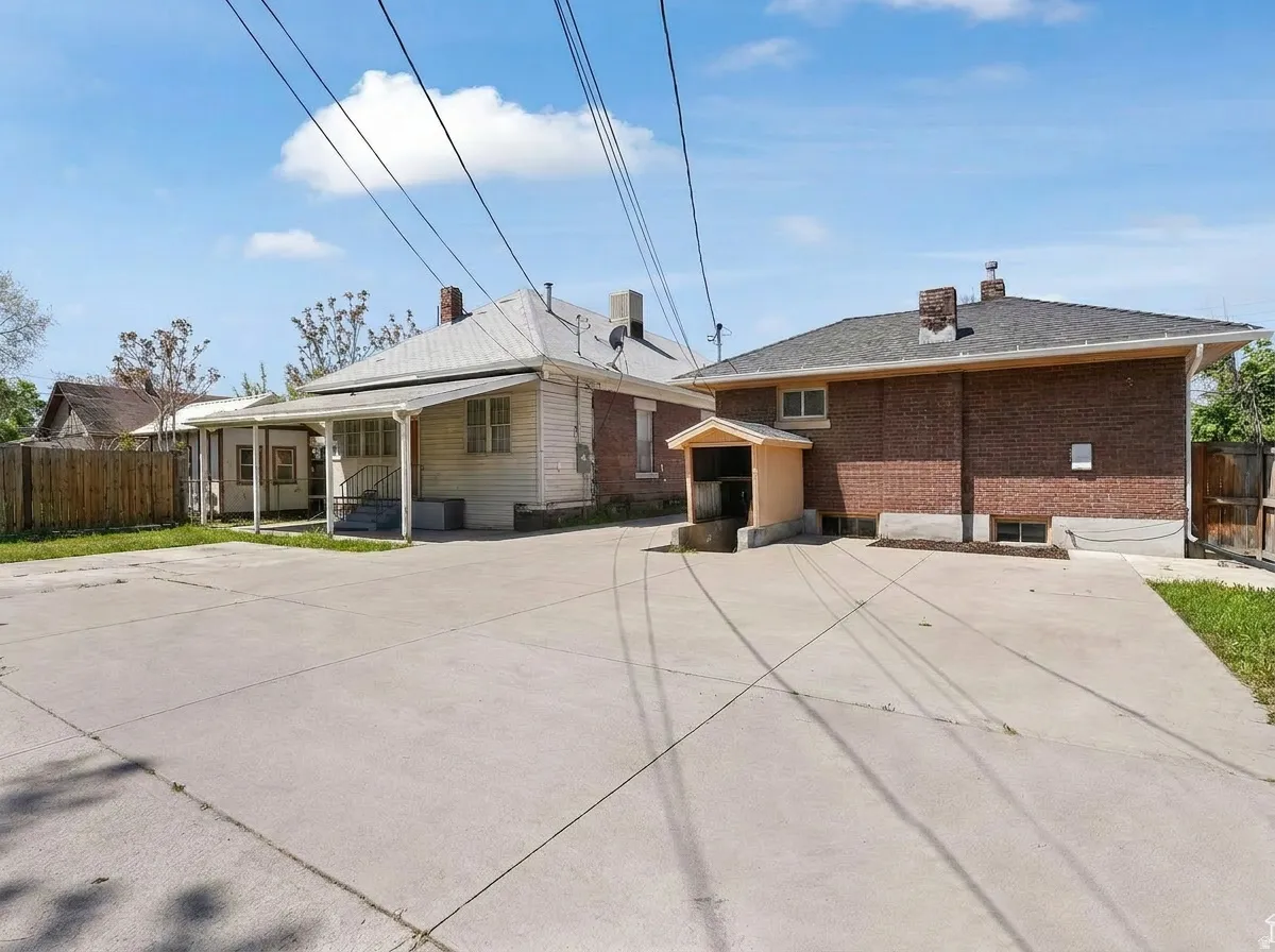 Expansive concrete driveway servicing two distinct residential structures