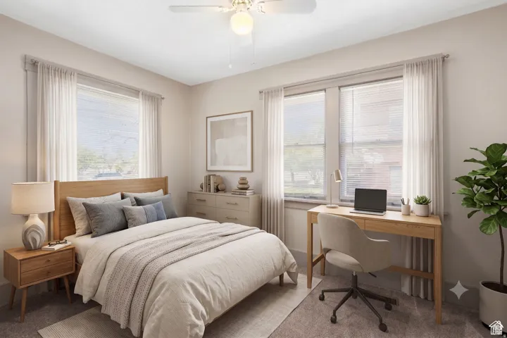 Bedroom featuring a ceiling fan with integrated lighting, wood-finish flooring, and multiple windows with blinds and drapery