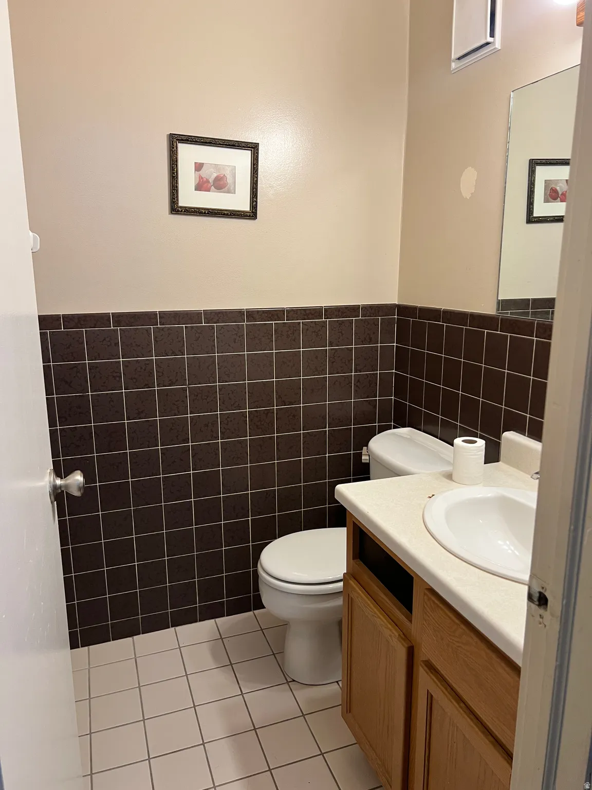 Bathroom featuring a vanity with a drop-in sink and wood-finish cabinetry