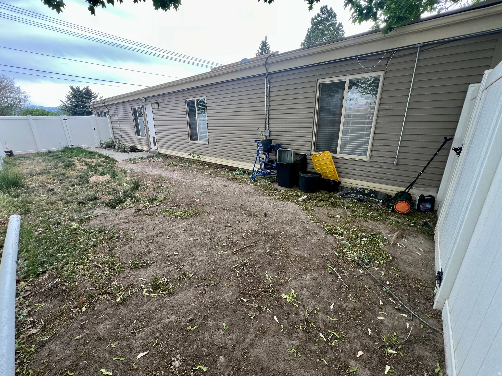 Exterior wall with horizontal siding and multiple windows