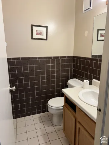 Bathroom featuring a vanity with a drop-in sink and wood-finish cabinetry