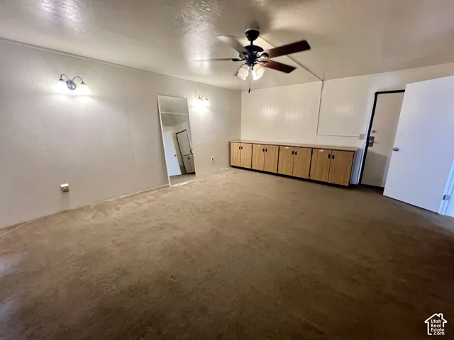 Interior room featuring carpeted flooring and white paneled walls