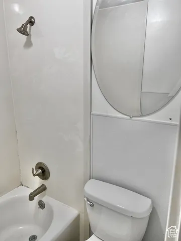 White tub-shower combination with brushed nickel fixtures