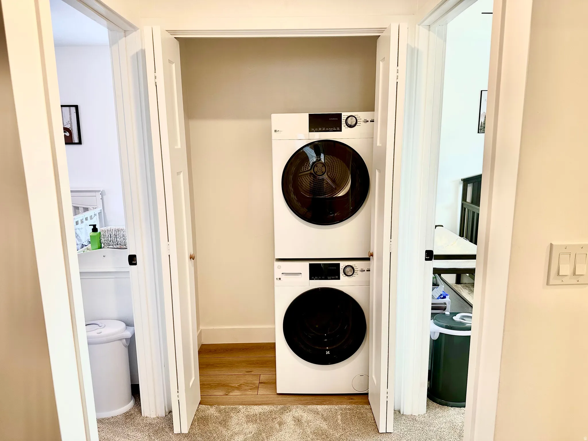 Integrated laundry closet featuring a stacked washer and dryer unit
