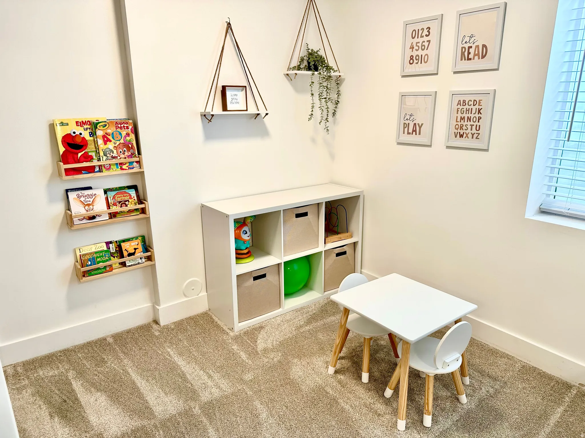 Wall-mounted book ledges and built-in shelving offer organized storage