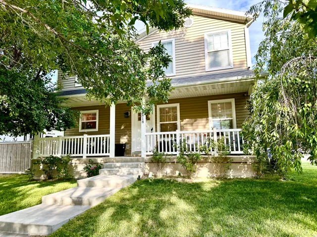 Two-story residence featuring horizontal siding and a covered front porch with white railing