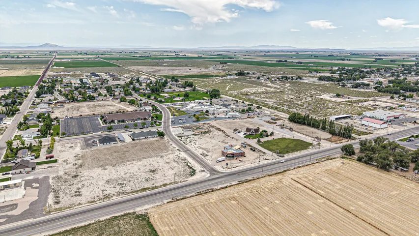 Expansive land parcel featuring open terrain, road frontage, and proximity to established residential areas