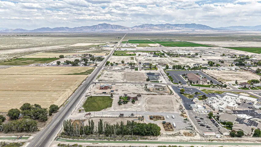 Expansive aerial perspective showcasing a rural landscape with distant mountains