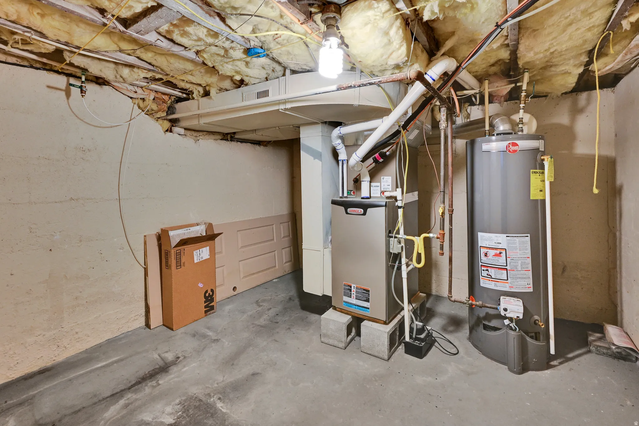 Utility area featuring a water heater, furnace, concrete flooring, and exposed ceiling insulation