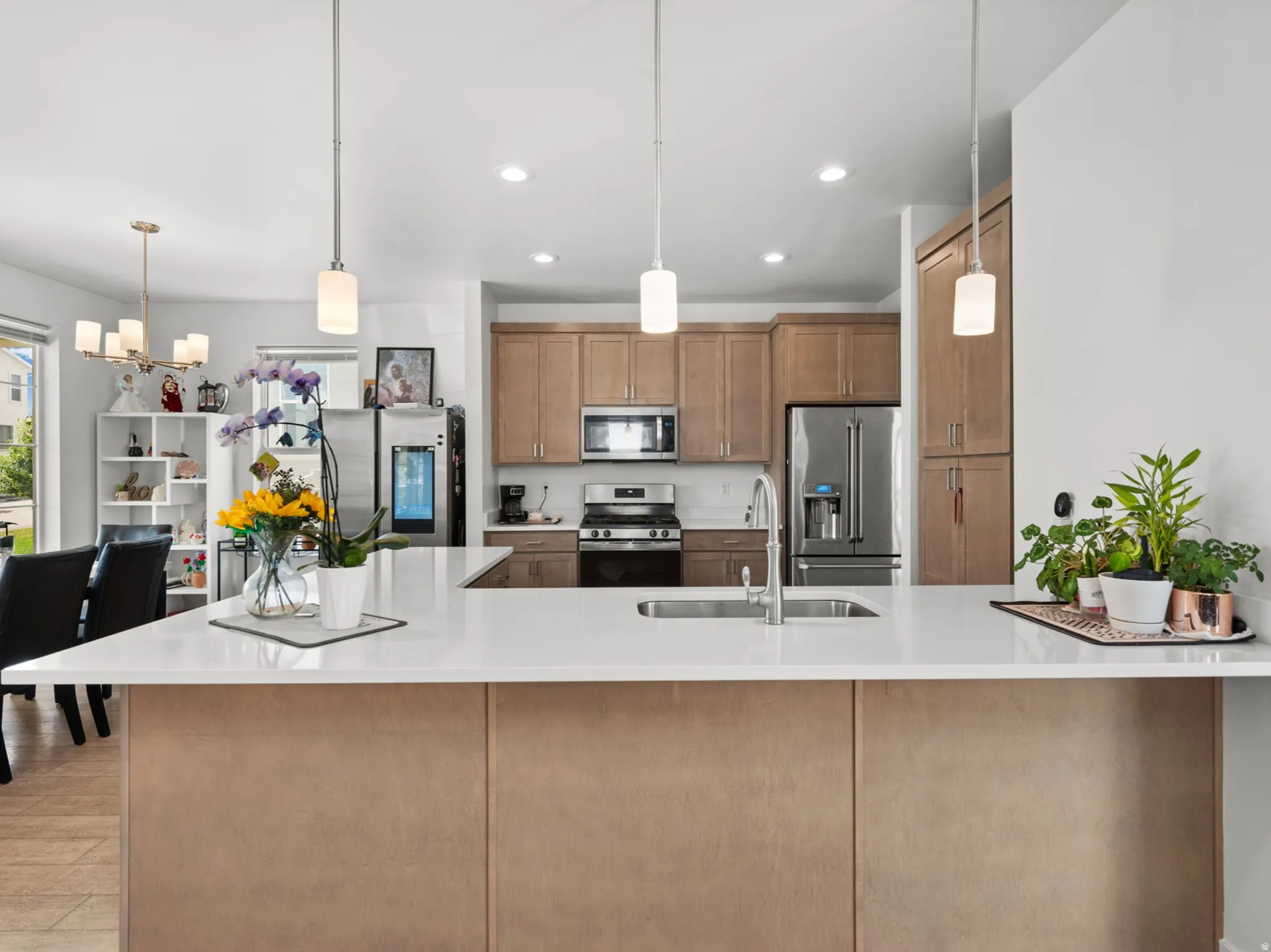 Kitchen island with a white solid surface countertop and undermount sink