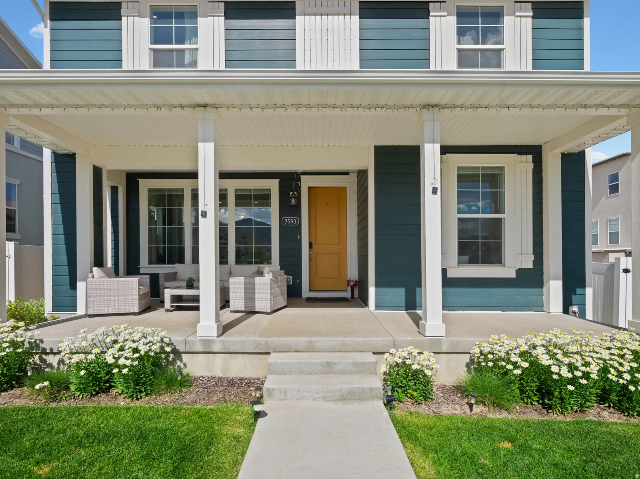 Two-story exterior with teal siding and white trim