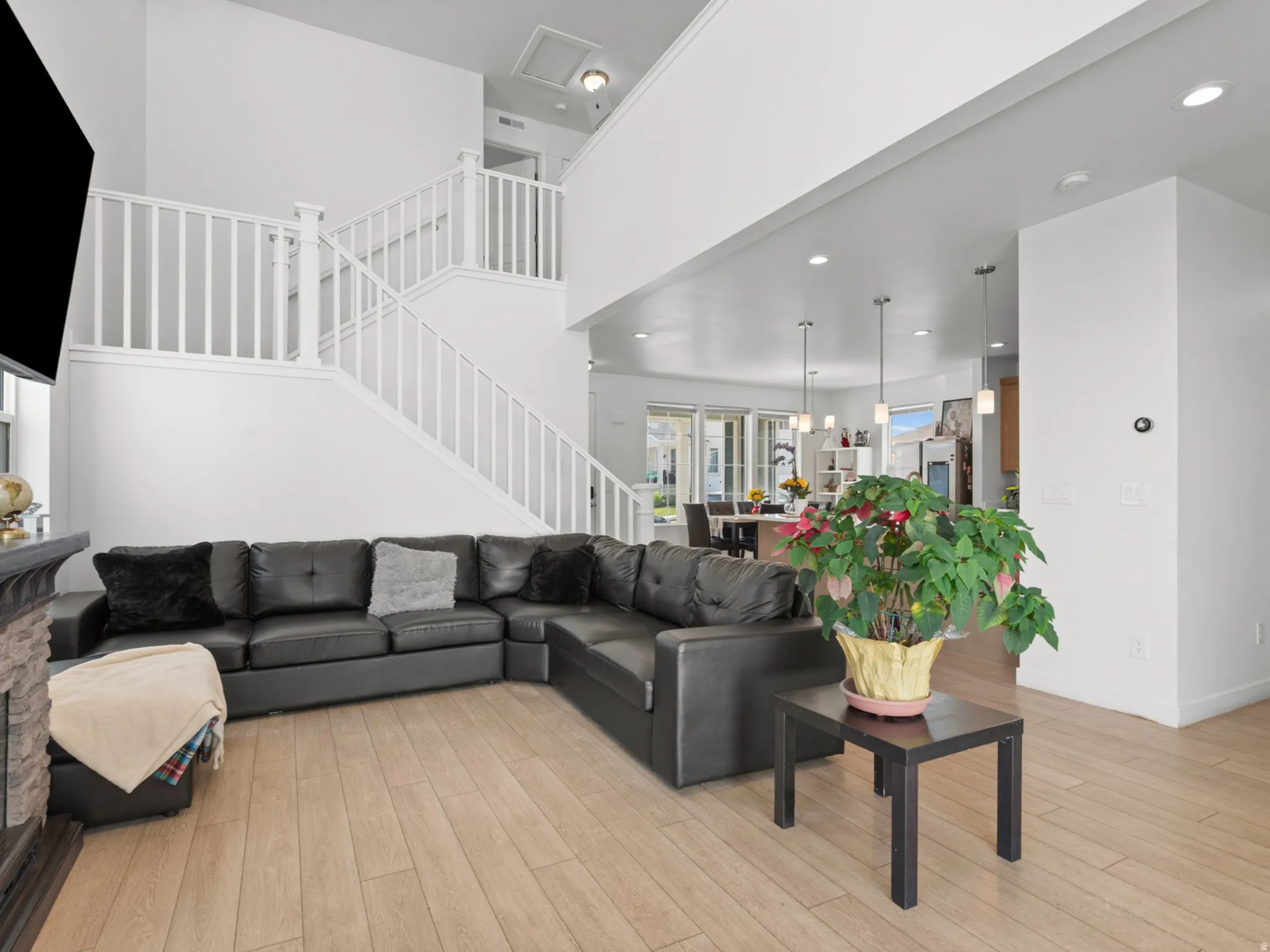 Open concept living area with wood-finish flooring