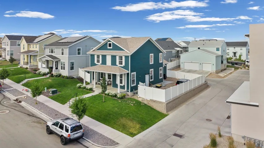 Two-story residence with a covered front porch, white window shutters, and a well-maintained lawn