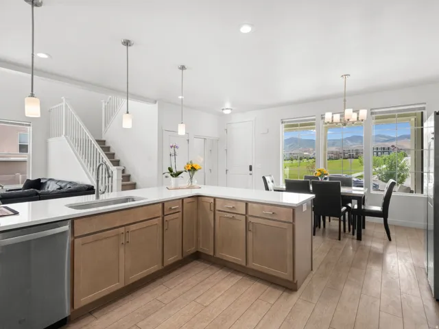 Spacious kitchen and dining area with light wood-finish flooring