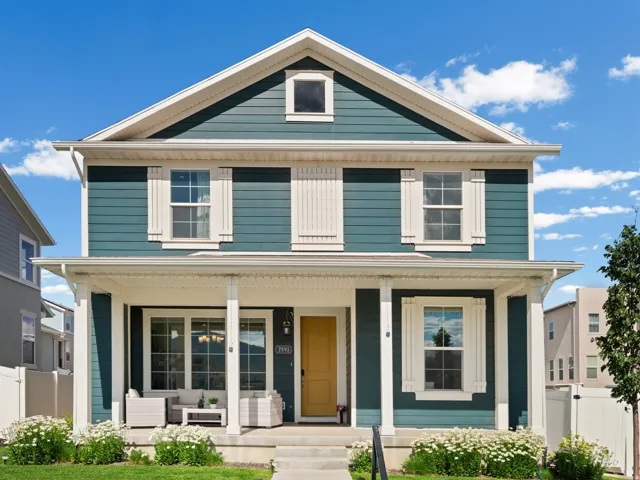 Two-story residence featuring teal horizontal siding and white trim