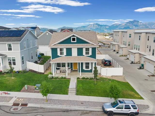 Two-story home with a teal facade and white trim