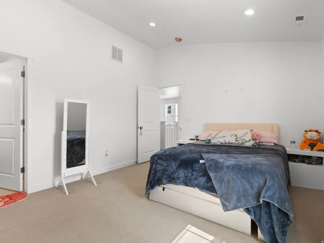 Vaulted ceilings featuring recessed lighting and carpeted flooring