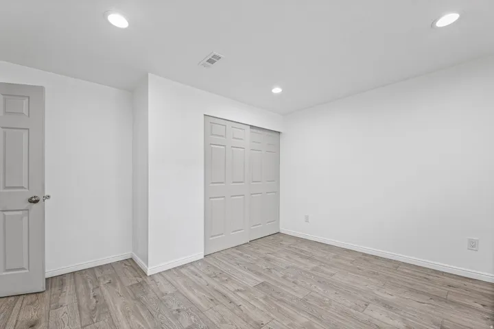 Another view of the secondary bedroom highlighting the closet space and versatile layout.