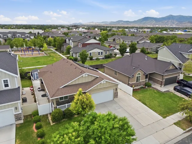 Back yard view is community park with playground, aerial view highlighting the property's fenced backyard, surrounding neighborhood, and convenient corner of the community.