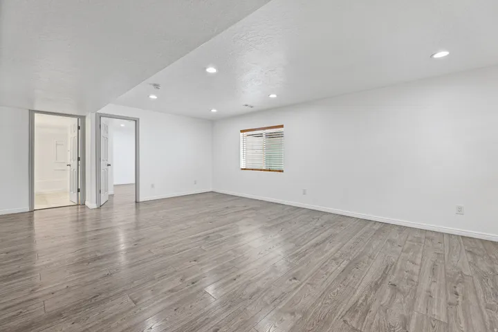 Expansive lower-level family room with an open layout, recessed lighting, and ample space for gathering, recreation, or entertaining.