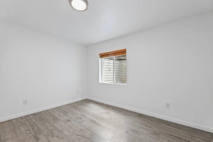 Another view of the secondary bedroom showcasing natural light, neutral finishes, and an easy-to-furnish floor plan.