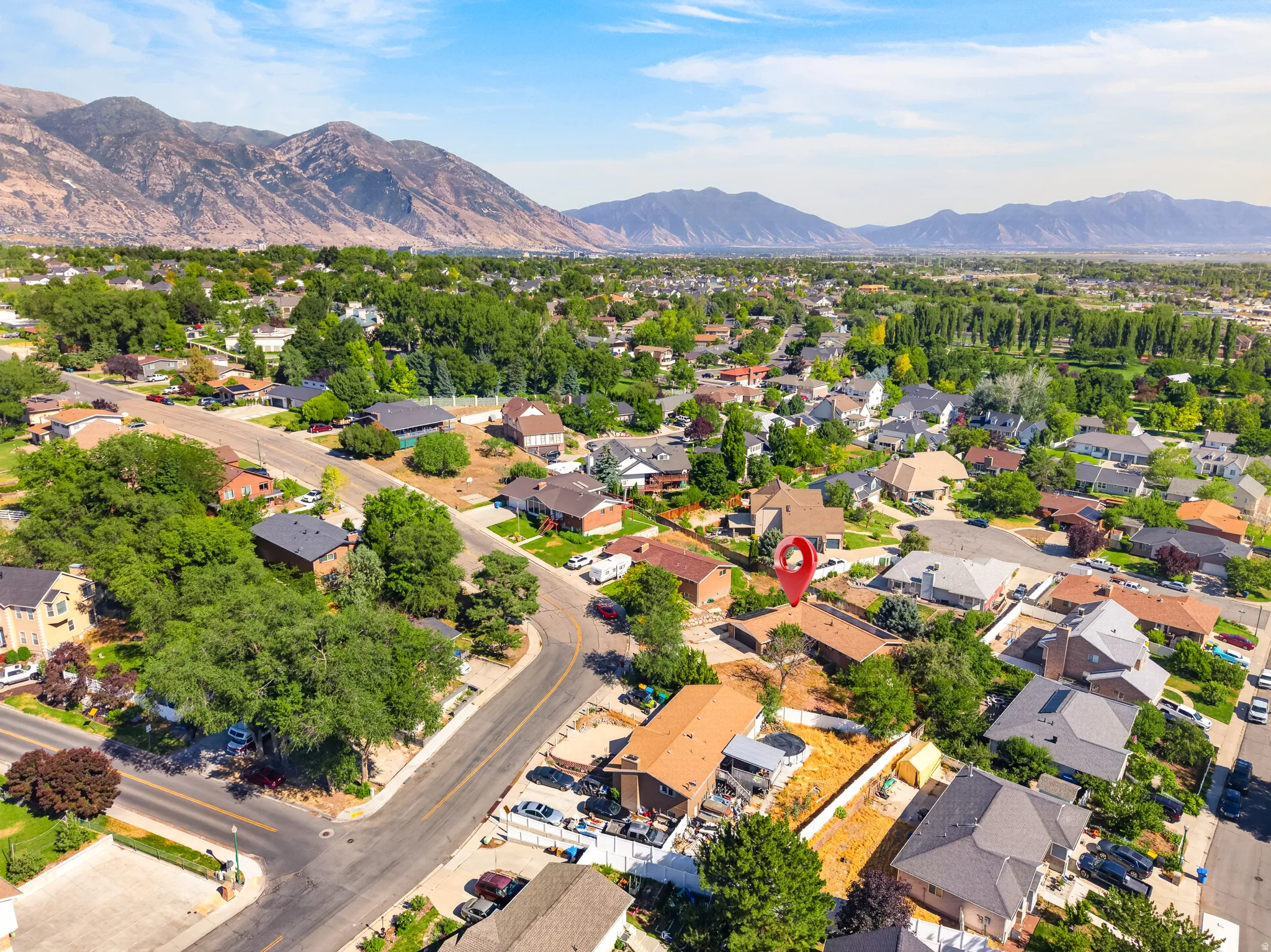 Aerial perspective showcasing a residential neighborhood with a backdrop of mountains