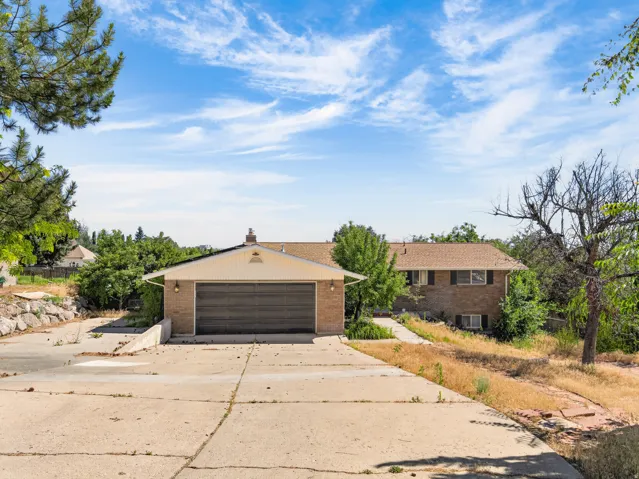 Brick exterior with a two-car garage and a concrete driveway