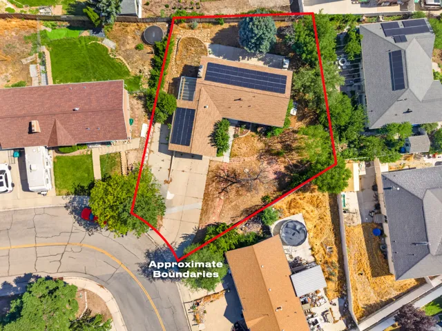 Rooftop solar panels visible on a residential property featuring a brown shingle roof