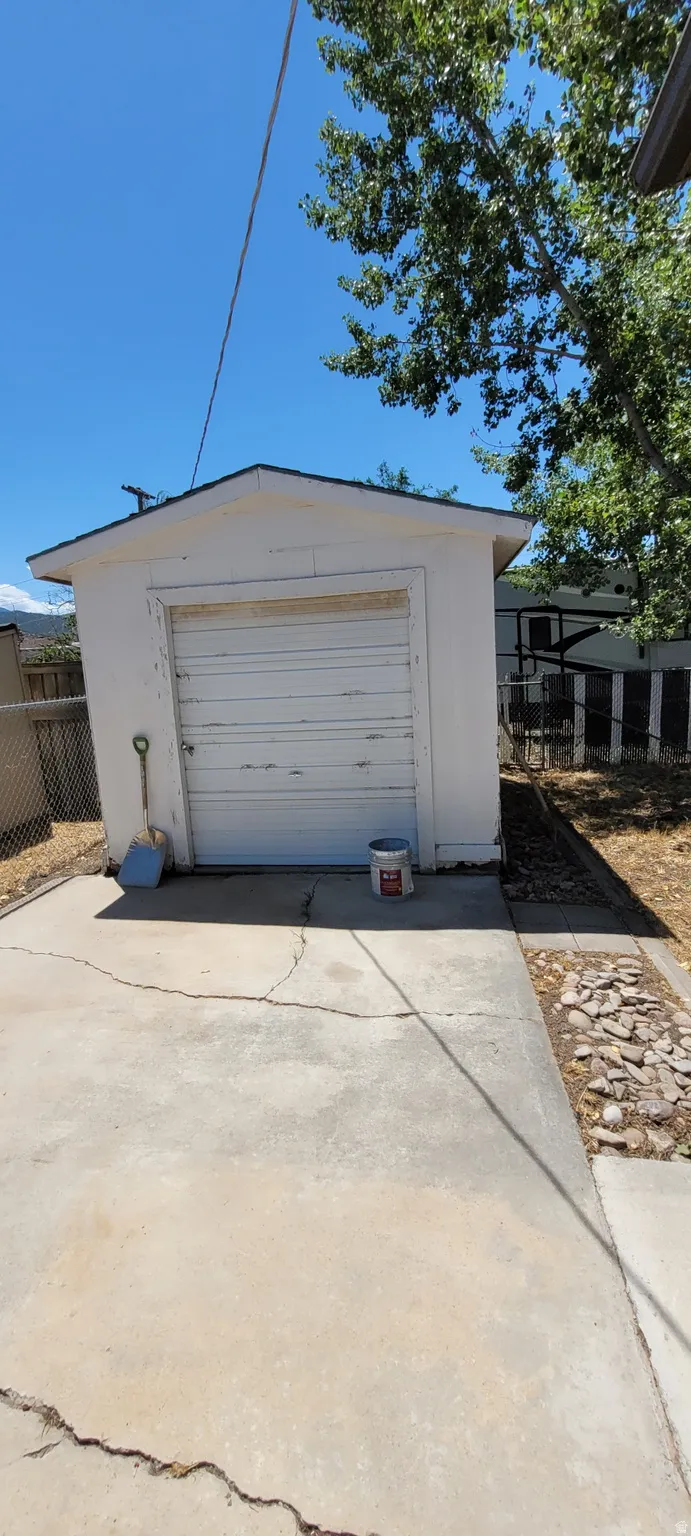 Detached garage structure featuring a roll-up garage door