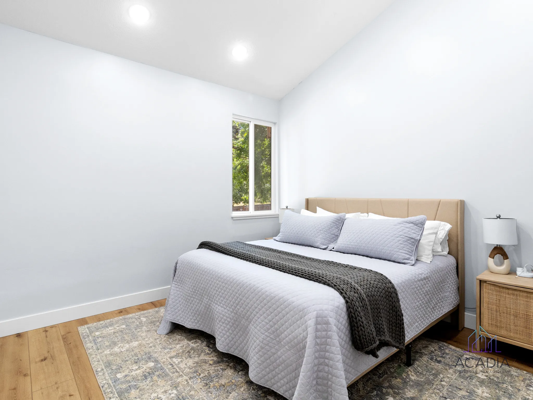 Bedroom featuring wood-finish flooring, recessed lighting, and a window with exterior views