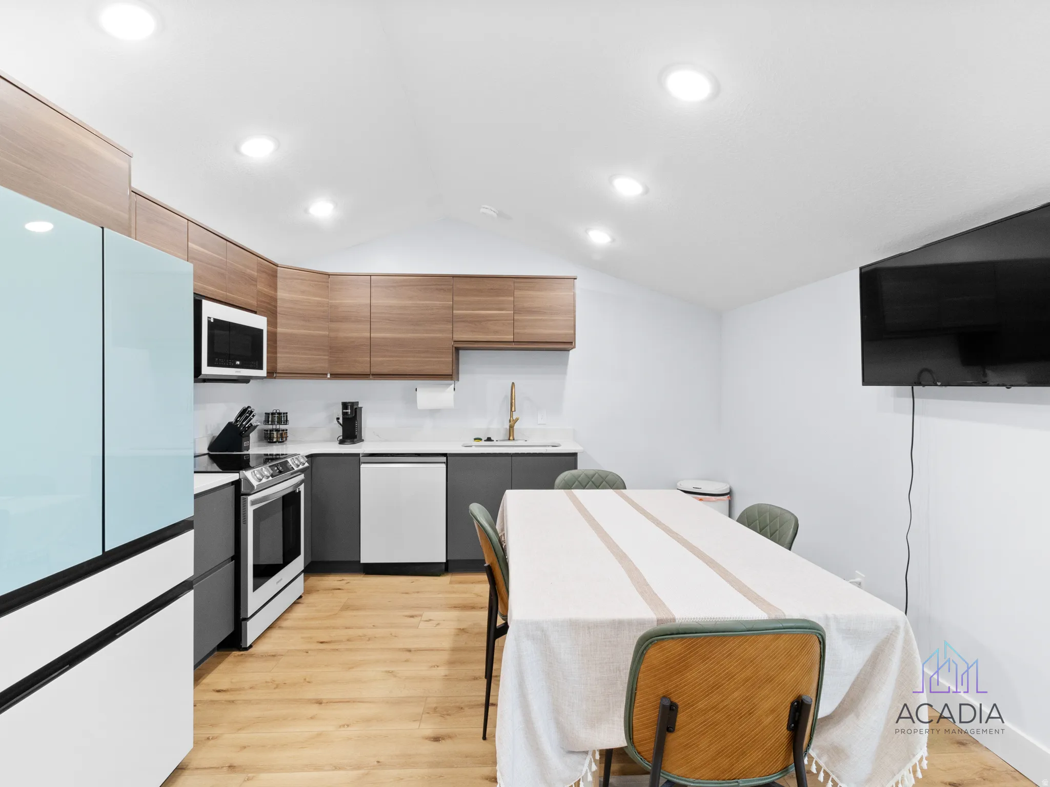Bright kitchen with wood-finish flooring and recessed lighting