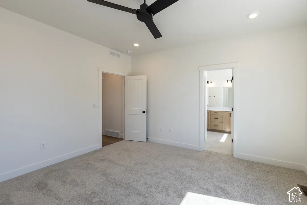 Spacious room with light neutral carpet and white walls