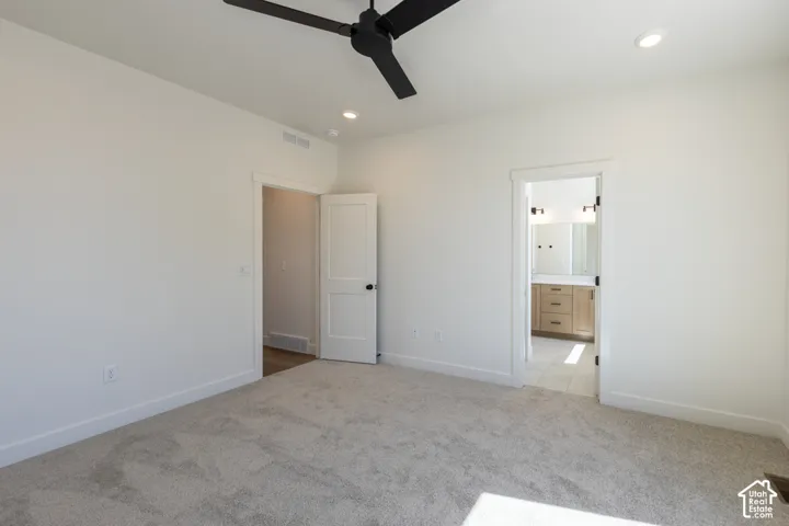Spacious room with light neutral carpet and white walls