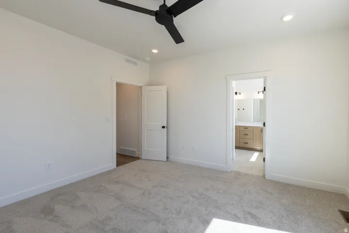 Spacious room with light neutral carpet and white walls