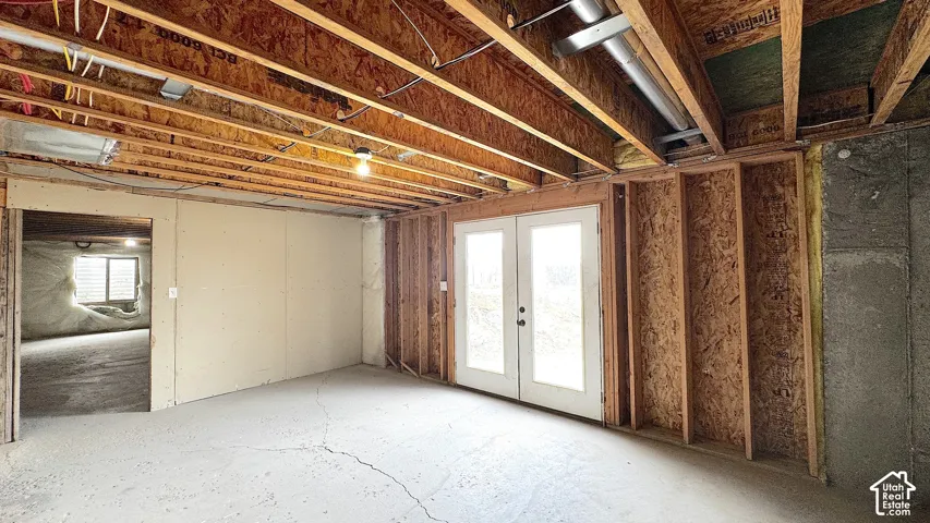 ADU possibility, French Doors to the backyard. Unfinished basement featuring exposed wood joists, concrete flooring.