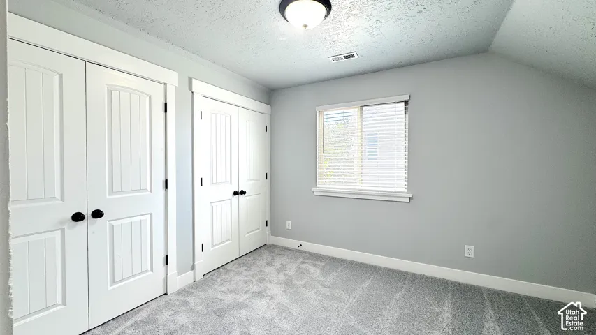 Bedroom featuring two sets of paneled double closet doors with matte black hardware