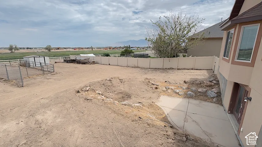 Expansive undeveloped land area with a concrete patio