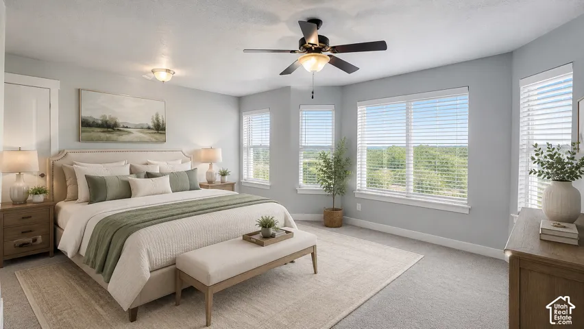 AI Staged Primary Bedroom, ceiling fan with integrated light, multiple windows, with brand new plush carpeting, and light gray walls.