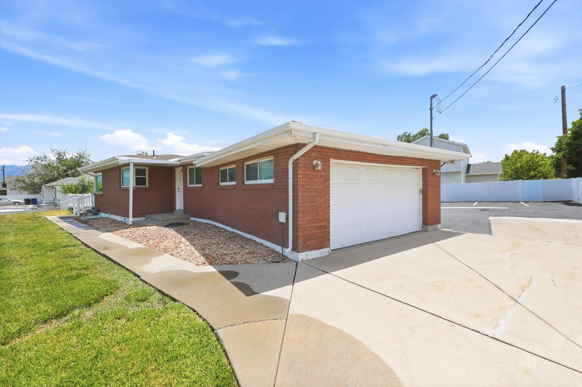 Brick exterior with an attached garage and a concrete driveway