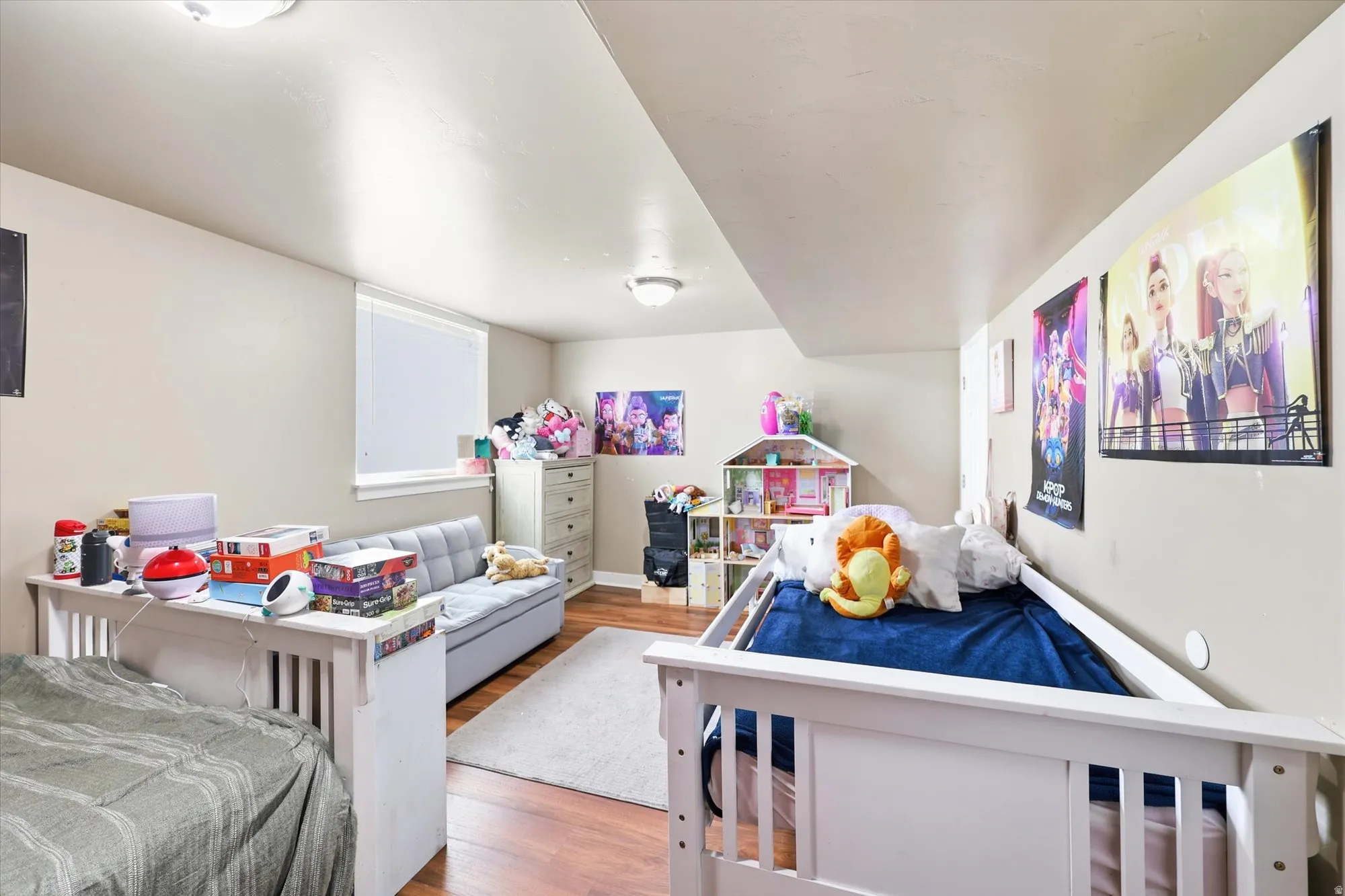 Expansive room featuring wood-finish flooring, light neutral wall paint, and recessed lighting