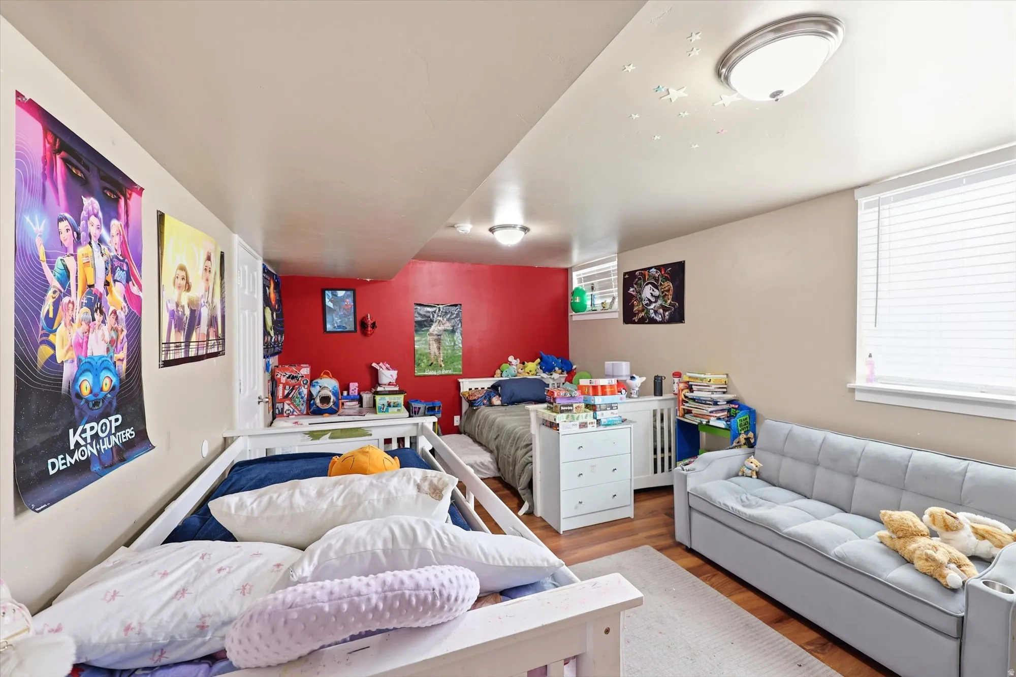 Room with wood-finish flooring, recessed lighting, and a window with blinds