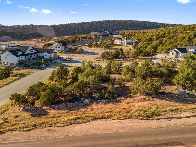 Expansive undeveloped lot featuring natural desert landscaping and paved road frontage