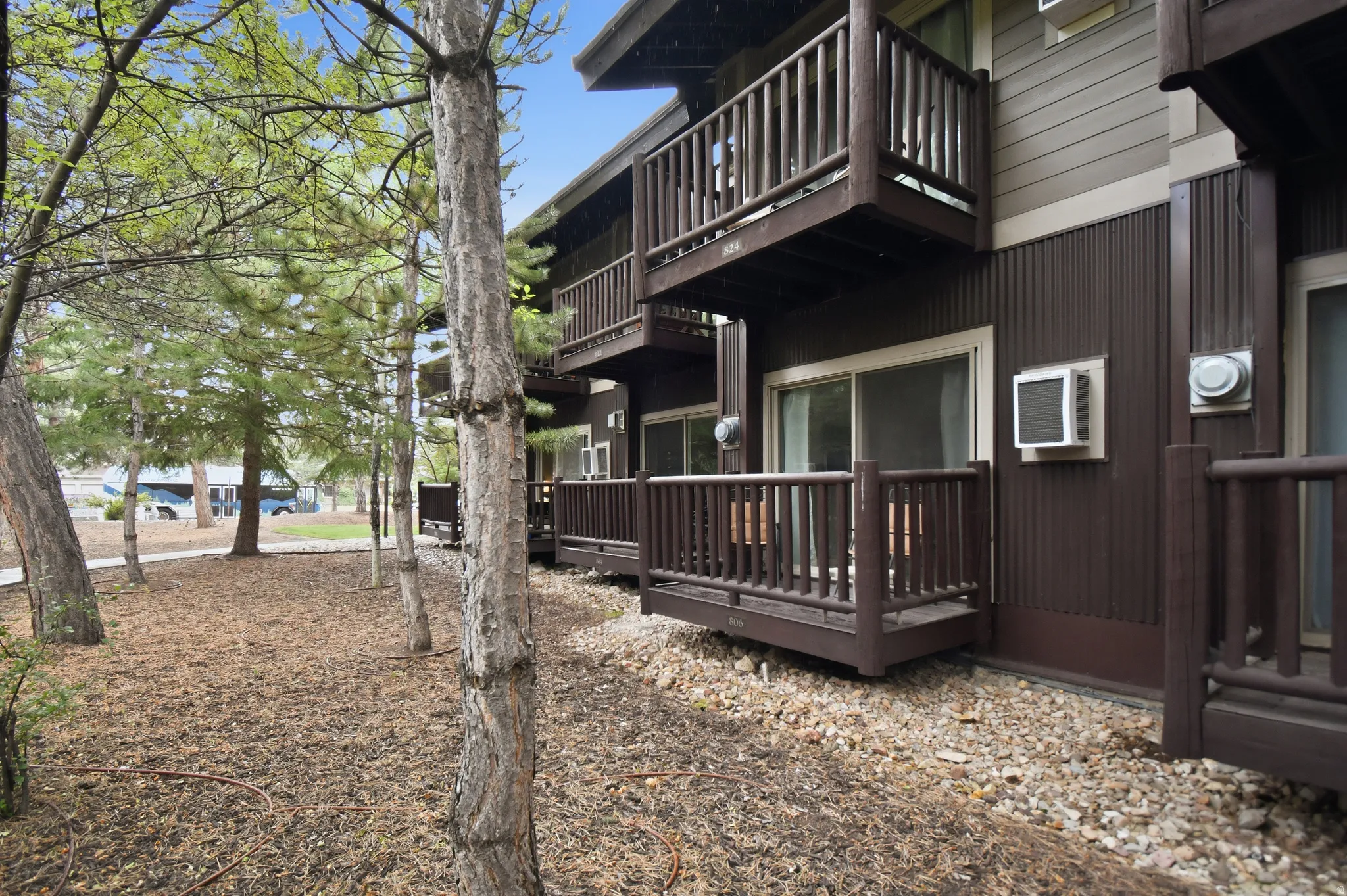 Multi-level residential building featuring private balconies and ground-floor patios