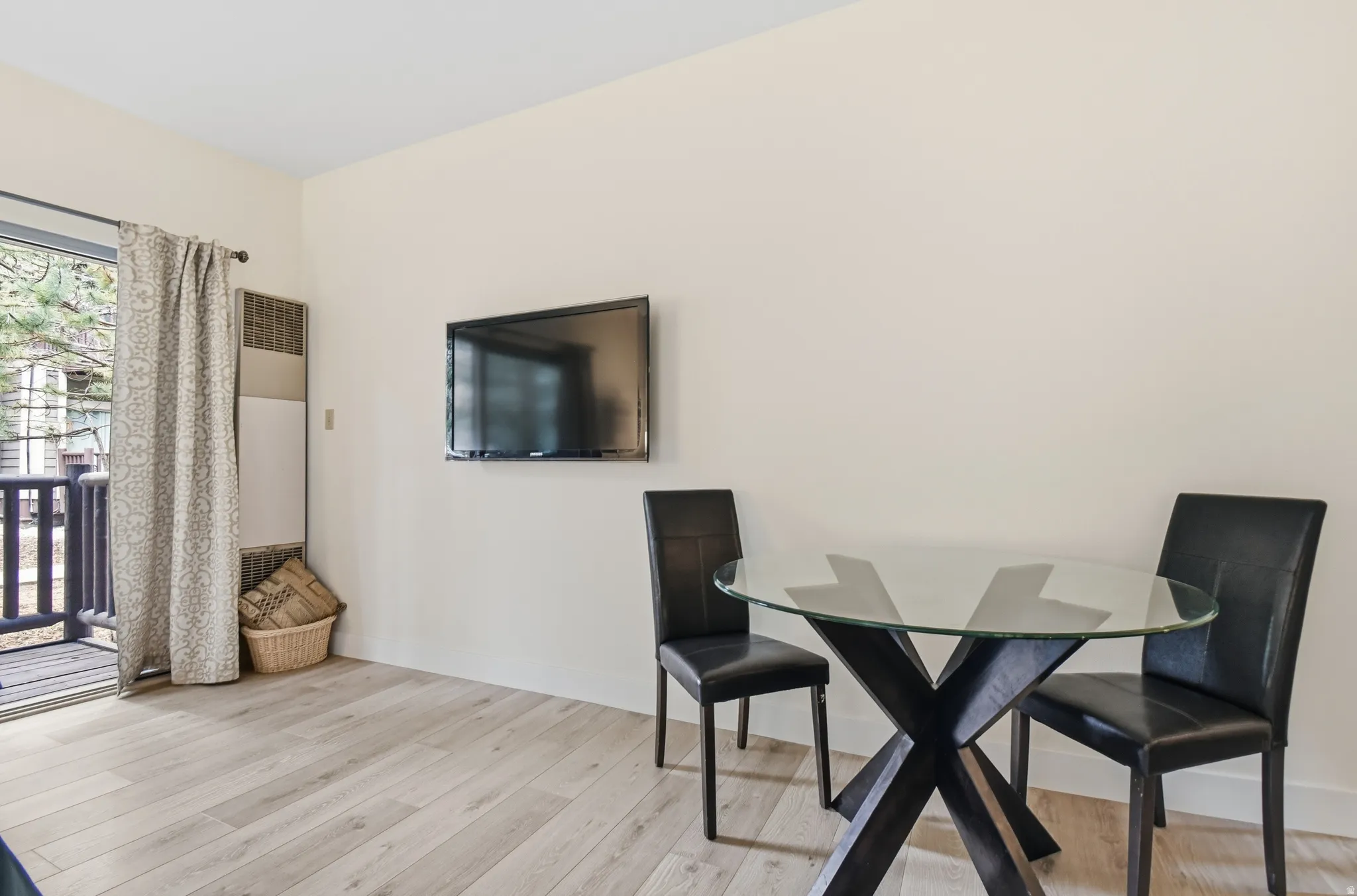 Light wood-finish flooring complements neutral wall tones
