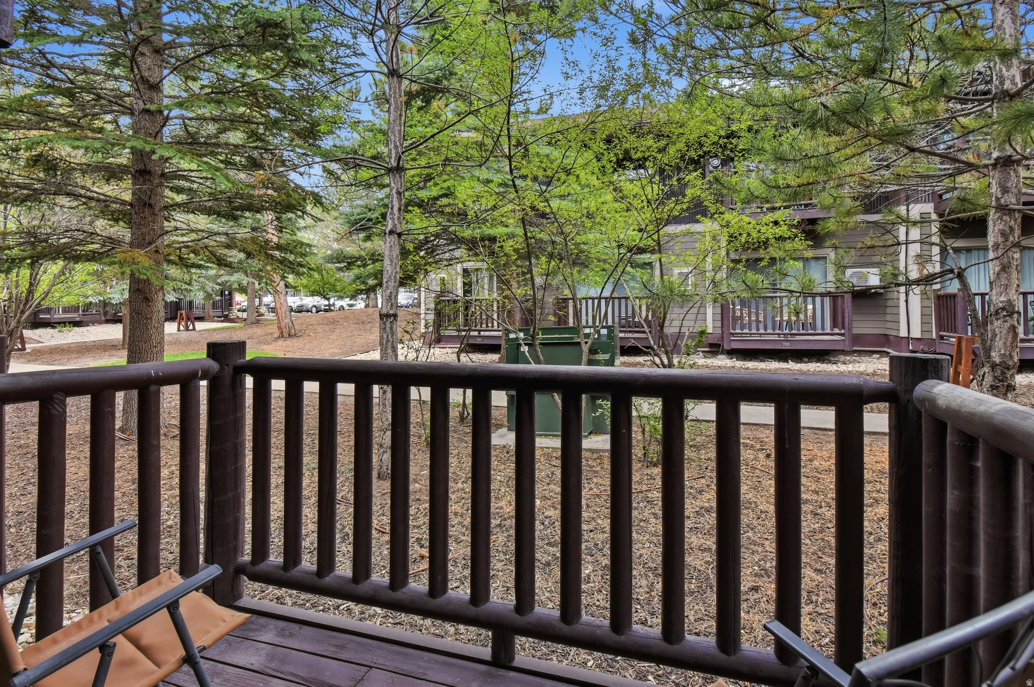 Private balcony featuring a wood-finish railing and decking