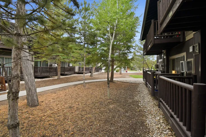 Brown-painted exterior with multiple private balconies and ground-level patios