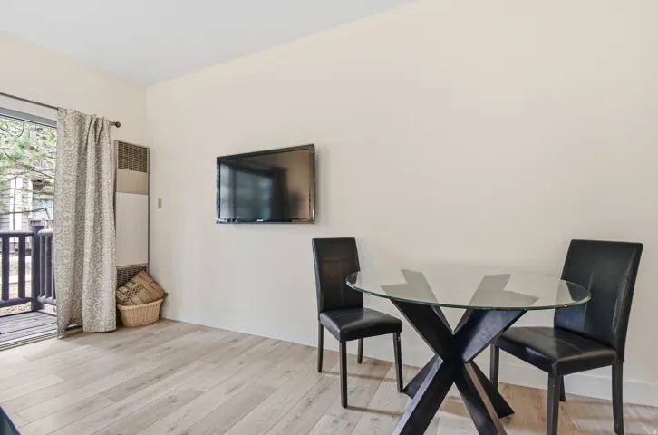 Light wood-finish flooring complements neutral wall tones