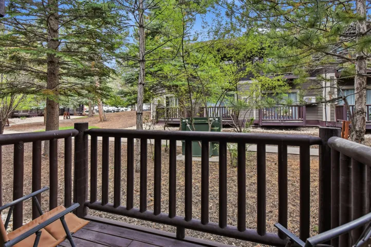 Private balcony featuring a wood-finish railing and decking