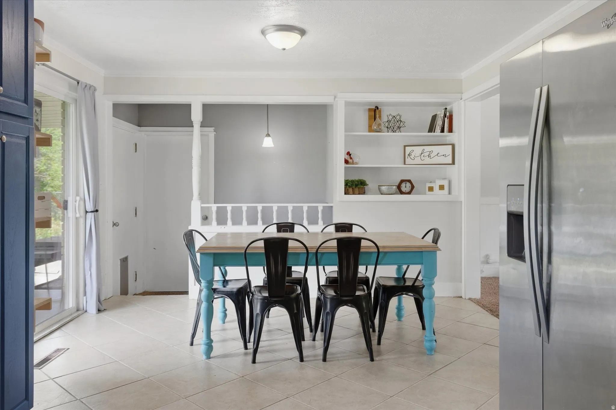 Dining area with light-toned tiled flooring