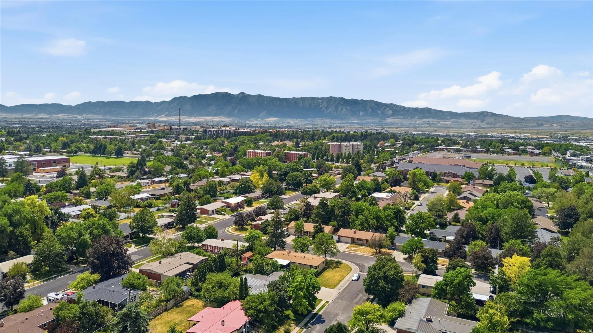 Expansive aerial perspective showcasing a residential area with mature tree coverage